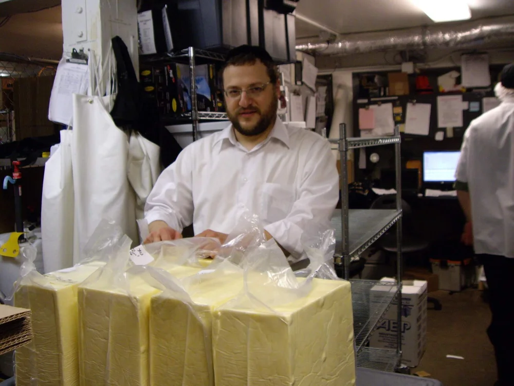 Rabbi marking cheese as kosher